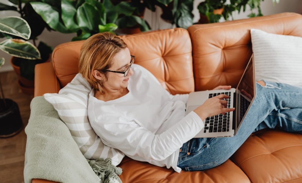 Woman in her 50s learning online from home, building new skills